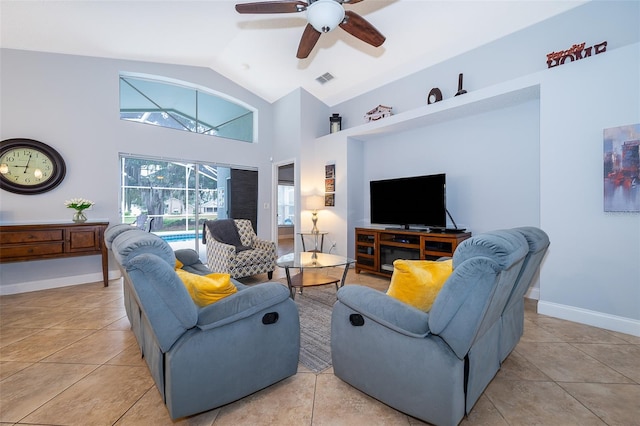 living room featuring lofted ceiling, ceiling fan, and light tile patterned floors