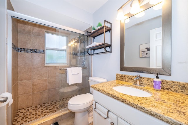 bathroom with an enclosed shower, vanity, and toilet