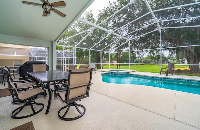 view of swimming pool with ceiling fan, a lanai, a patio, and an in ground hot tub