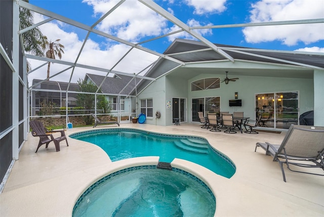 view of pool with a lanai, an in ground hot tub, ceiling fan, and a patio