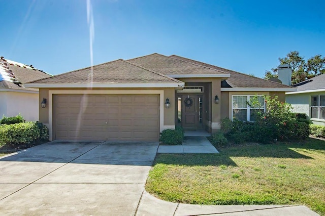 view of front facade with a front lawn and a garage