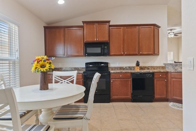 kitchen with dark stone countertops, ceiling fan, black appliances, and vaulted ceiling