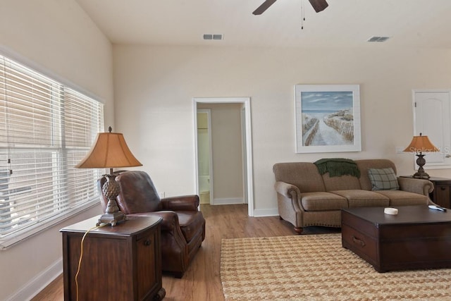 living room featuring ceiling fan and light hardwood / wood-style floors