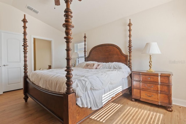 bedroom featuring ceiling fan, vaulted ceiling, and light hardwood / wood-style flooring