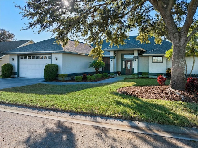 ranch-style house featuring a front yard and a garage