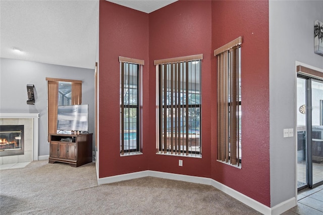 foyer with a fireplace and light carpet