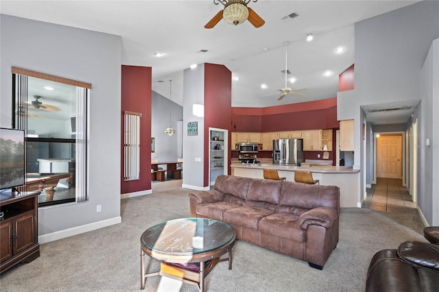 carpeted living room featuring high vaulted ceiling