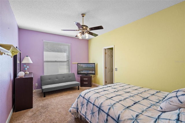 carpeted bedroom with ceiling fan and a textured ceiling