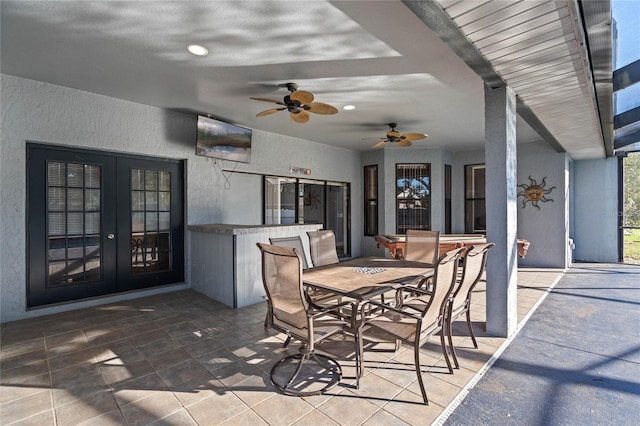 view of patio with french doors and a bar