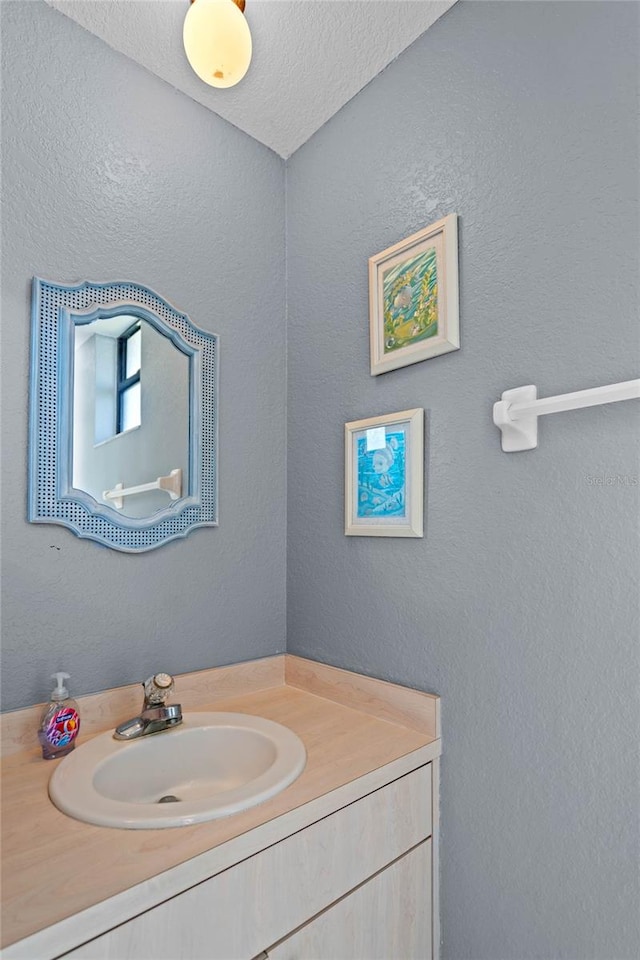 bathroom featuring vanity and a textured ceiling