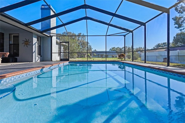 view of pool with glass enclosure