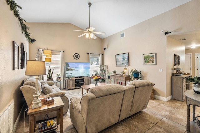 living room featuring lofted ceiling, light tile patterned floors, and ceiling fan