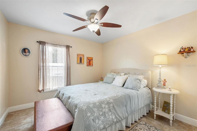 tiled bedroom featuring ceiling fan