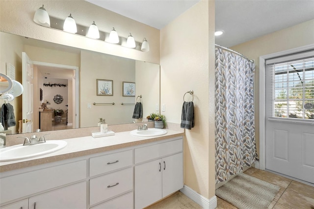 bathroom with tile patterned flooring and vanity