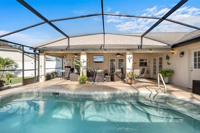 view of swimming pool featuring a lanai, ceiling fan, outdoor lounge area, a patio, and french doors