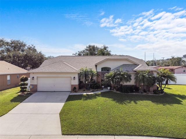 single story home featuring a garage and a front yard