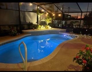 view of pool with a lanai and a patio area