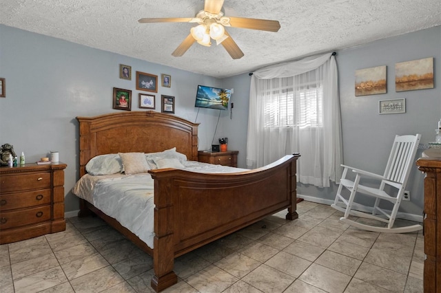 bedroom with ceiling fan and a textured ceiling