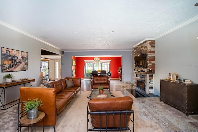 living room with crown molding, a large fireplace, a chandelier, and light wood-type flooring