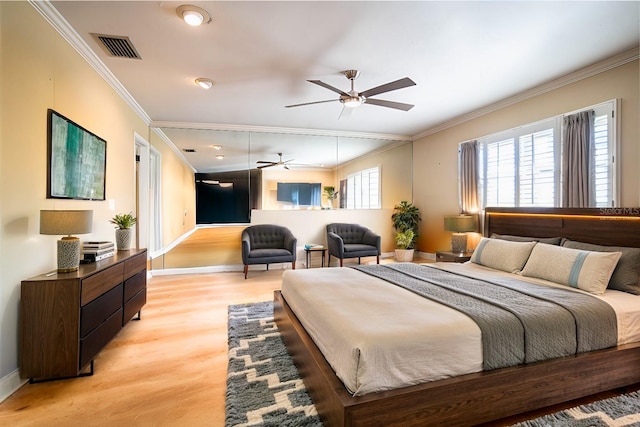 bedroom with crown molding, light hardwood / wood-style flooring, and ceiling fan