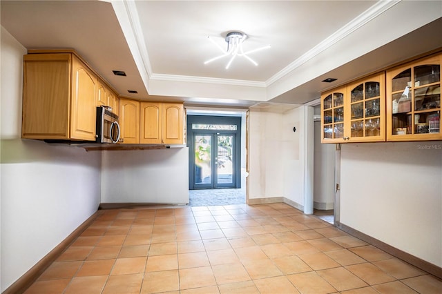 kitchen with light brown cabinets, french doors, crown molding, and a tray ceiling