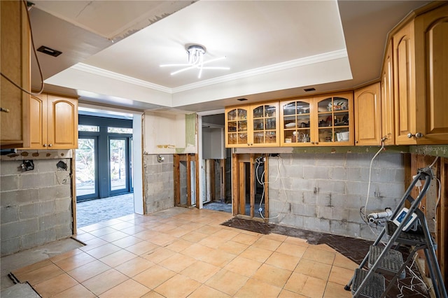 kitchen with a raised ceiling and crown molding