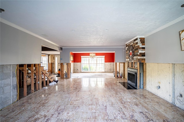 unfurnished living room with a fireplace and crown molding