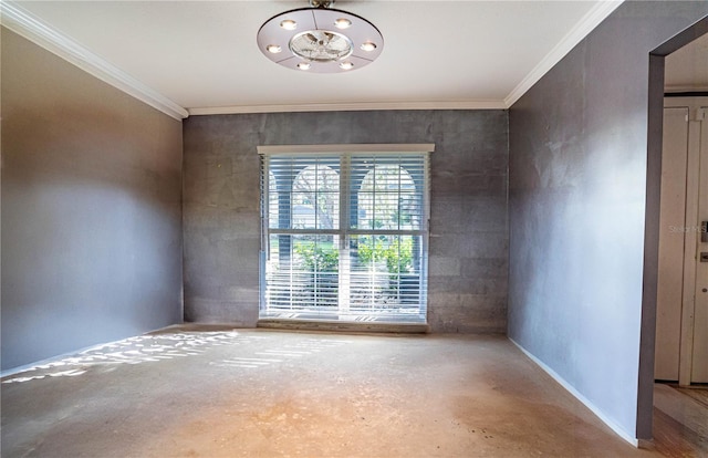 spare room featuring crown molding and concrete flooring