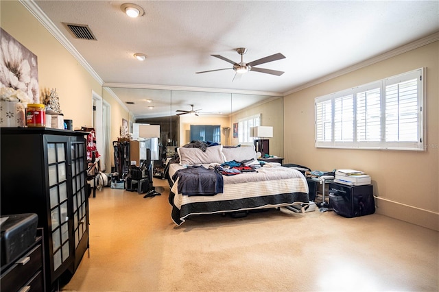 carpeted bedroom featuring crown molding, ceiling fan, and a textured ceiling