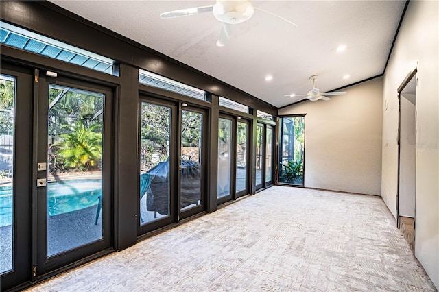 interior space with a textured ceiling, vaulted ceiling, ceiling fan, and ornamental molding