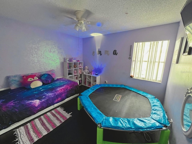 bedroom featuring a textured ceiling and ceiling fan