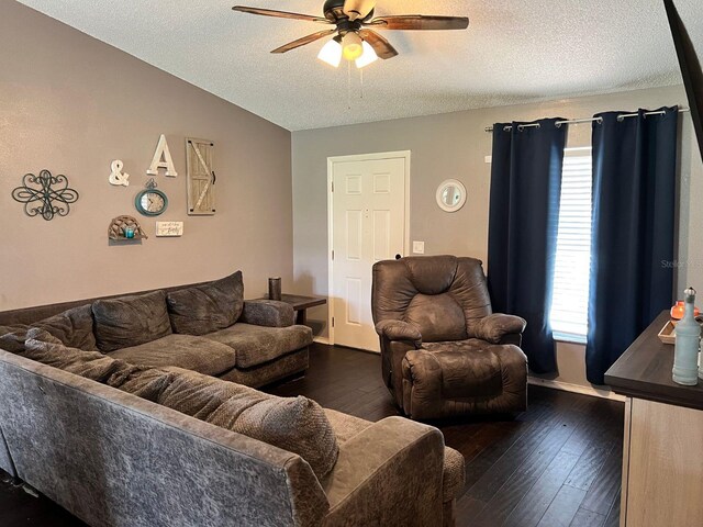 living room with dark hardwood / wood-style floors, ceiling fan, lofted ceiling, and a textured ceiling