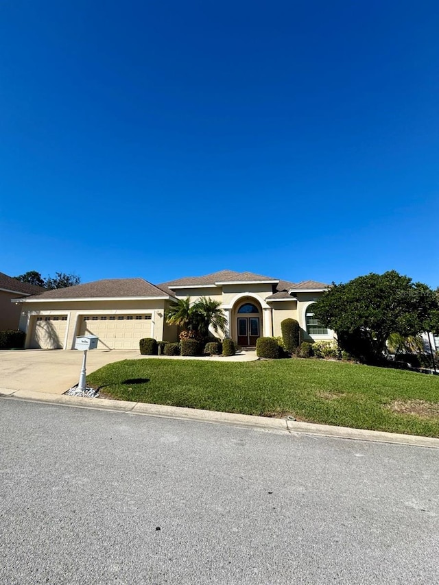 view of front facade with a garage and a front lawn