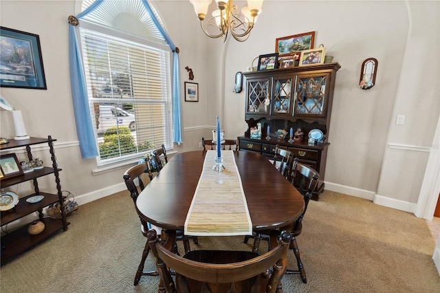 carpeted dining area featuring a notable chandelier