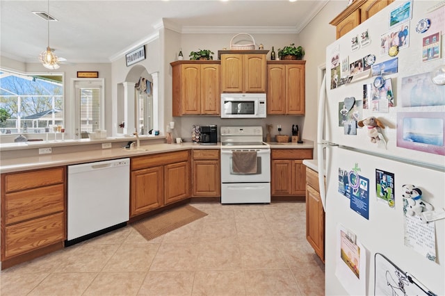 kitchen with sink, decorative light fixtures, light tile patterned floors, ornamental molding, and white appliances