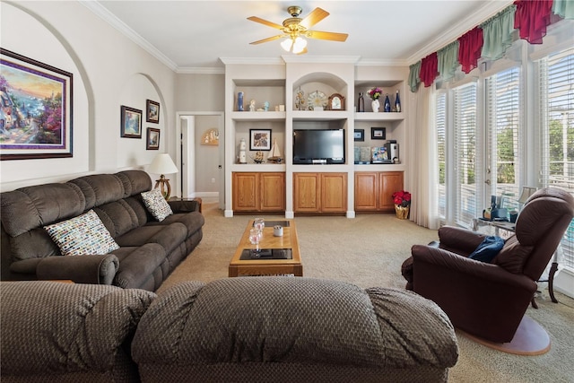 living room with light carpet, crown molding, built in shelves, and ceiling fan