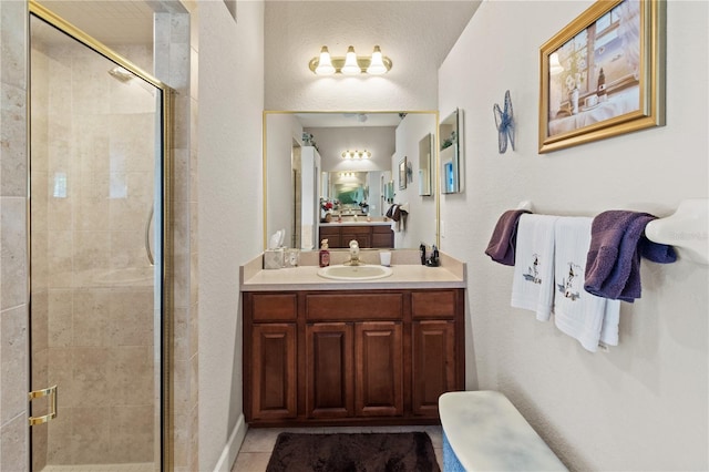 bathroom featuring tile patterned flooring, vanity, and an enclosed shower