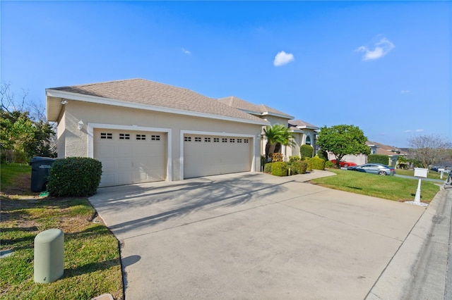 view of front of property featuring a garage and a front yard