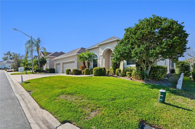 view of front of house featuring a garage and a front yard