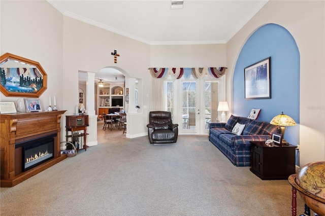 carpeted living room featuring ornamental molding and decorative columns