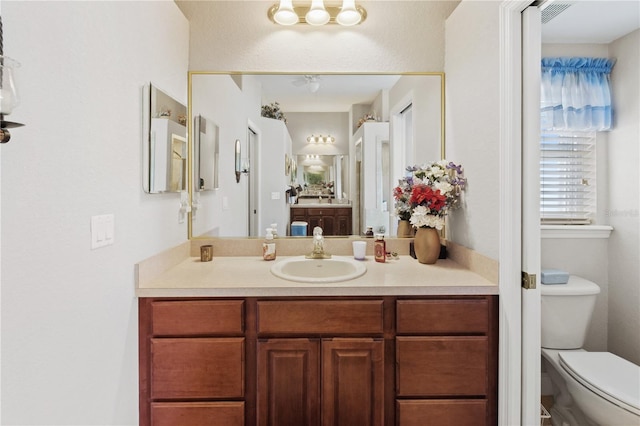 bathroom with vanity and toilet