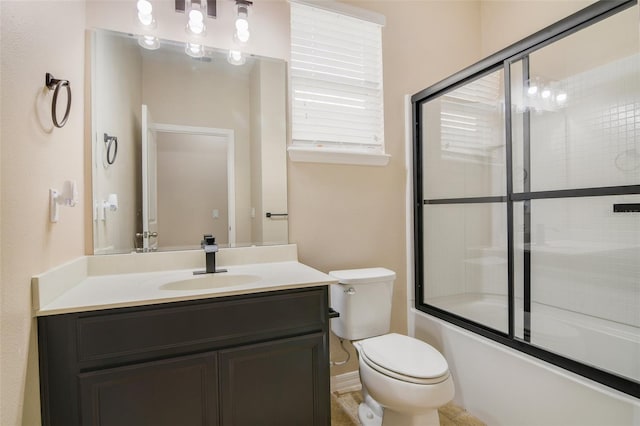 full bathroom with combined bath / shower with glass door, toilet, and vanity