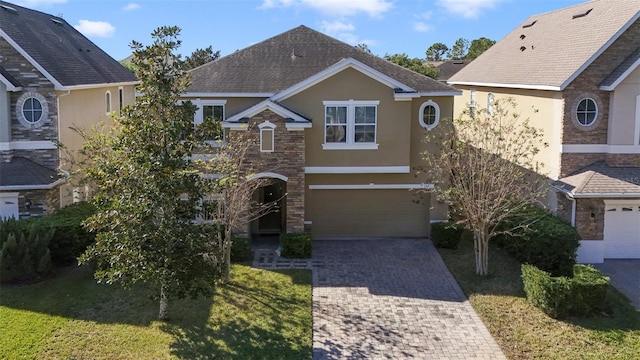 front facade with a garage and a front lawn