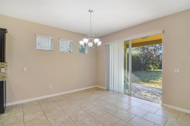 unfurnished dining area featuring a chandelier, light tile patterned floors, and a fireplace