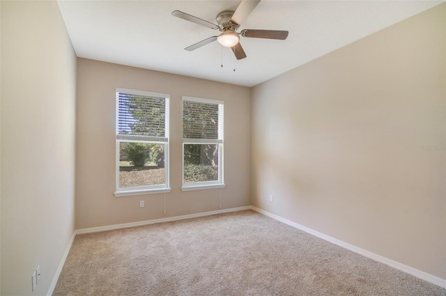 spare room featuring ceiling fan and light colored carpet