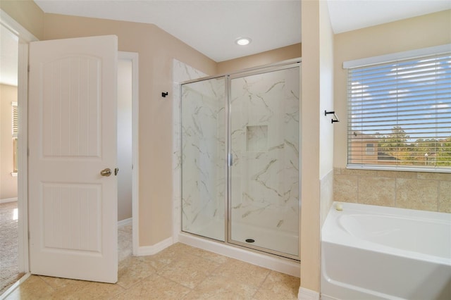 bathroom featuring shower with separate bathtub