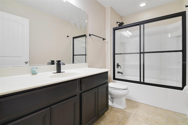 full bathroom with vanity, bath / shower combo with glass door, and toilet