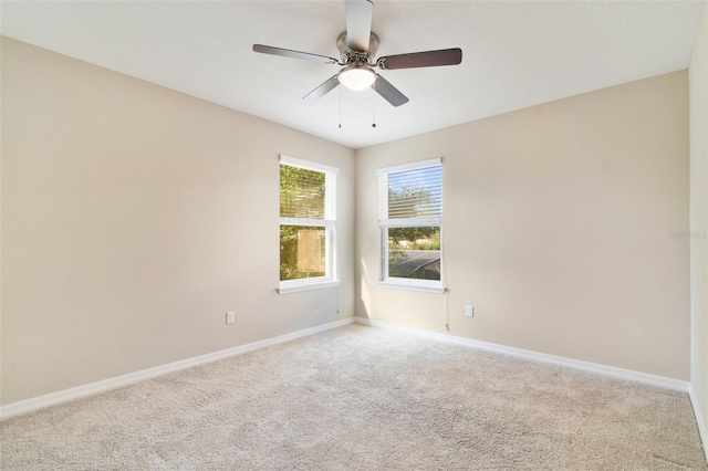 empty room featuring light carpet and ceiling fan