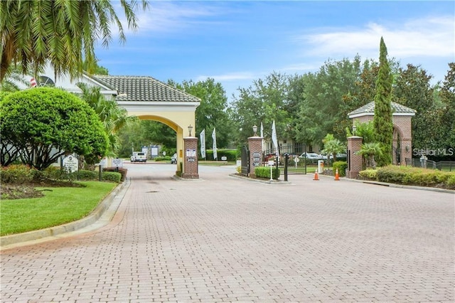 surrounding community featuring decorative driveway