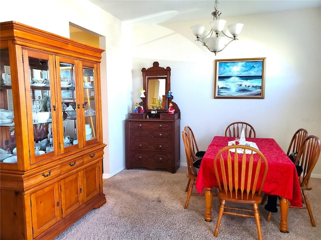 dining room with light colored carpet and a notable chandelier